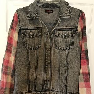 Jean jacket with flannel plaid sleeves.